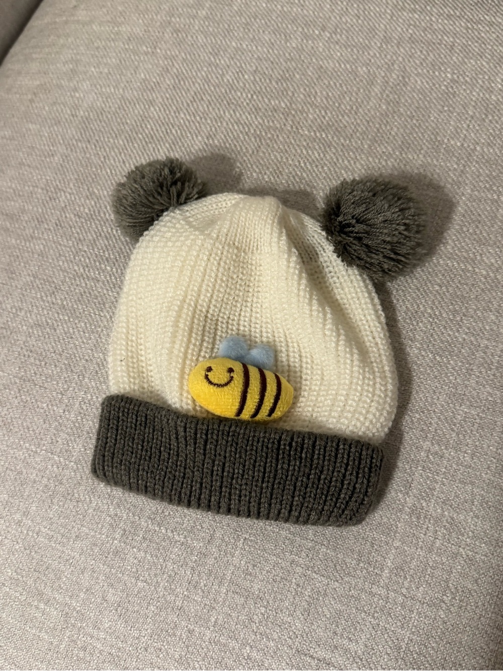 Cream Knit Beanie with Gray Pom Poms and Yellow Bee Accent